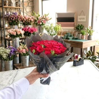 Send Elegantly Handmade Red Roses Bouquet in Black Wrapping to Pakistan